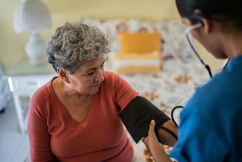 Elderly woman having blood pressure checked