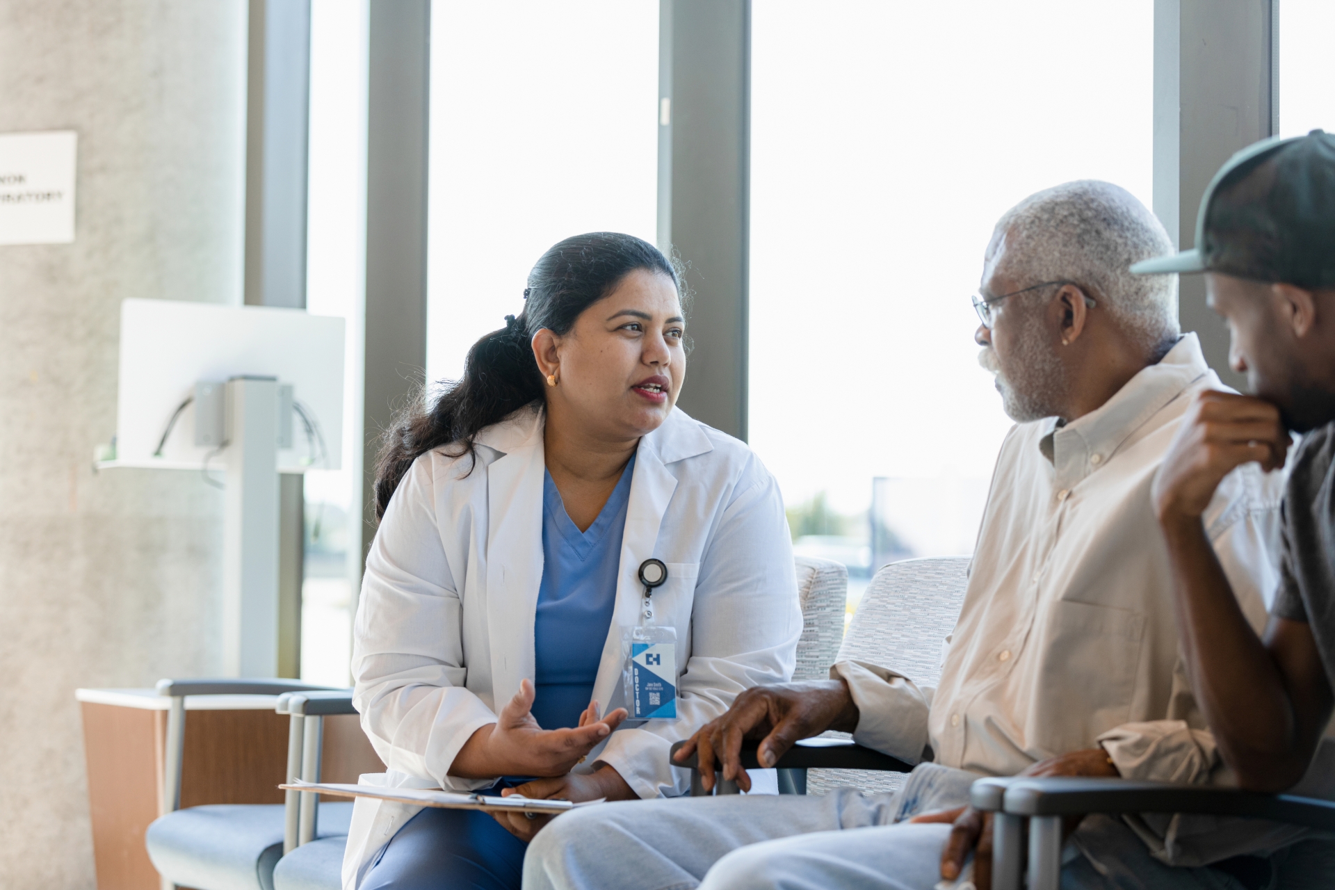Compassionate female doctor discusses medical issues with senior patient