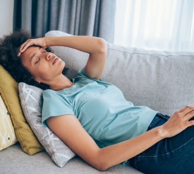 Ill woman lying on the sofa