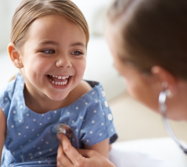 smiling child with pediatrcian