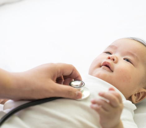 Doctor exams Asian newborn baby with stethoscope in the hospital