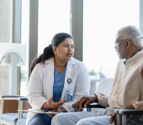 Compassionate female doctor discusses medical issues with senior patient