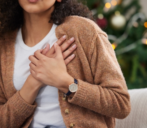 young woman holding her chest in pain