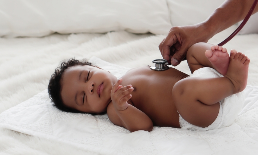 african american baby girl being health checkup with stethoscope
